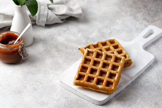 Breakfast waffles with chocolate sauce. Waffles empty on white board