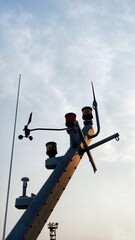 Radar, navigation and radio antennas on the deck of a boat. The antennas of vessel with sky background. navigation bridge deck with mast communication antena radio and exhaust on retro filter tone.