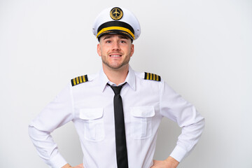 Airplane caucasian pilot isolated on white background posing with arms at hip and smiling