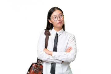 Young Asian business woman over isolated background looking up while smiling
