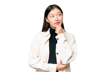 Young Asian woman over isolated chroma key background thinking an idea while looking up