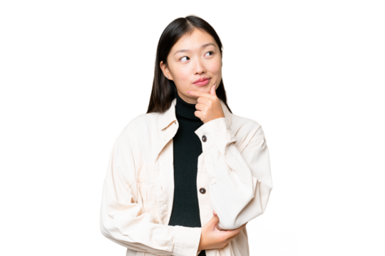 Young Asian woman over isolated chroma key background thinking an idea while looking up