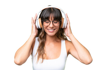Young caucasian woman over isolated background listening music