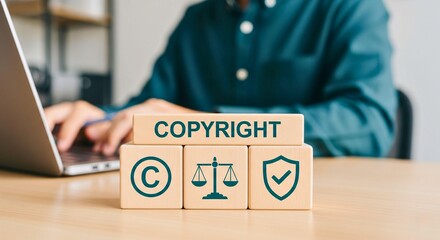 Protecting Intellectual Property: A focused individual works diligently on a laptop, emphasizing the crucial concept of copyright and the protection of creative assets and original ideas.