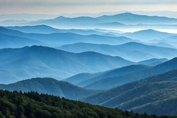 Obraz premium Layers of blue mountains fading into the distance under a hazy sky