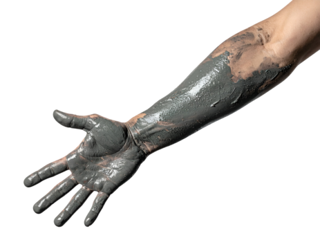 Human arm covered with therapeutic black mud spa treatment on isolated white background