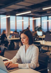 Fototapeta premium Focused Female at Work: A determined businesswoman diligently works on her laptop in a modern, collaborative office environment, bathed in the soft glow of the workspace.