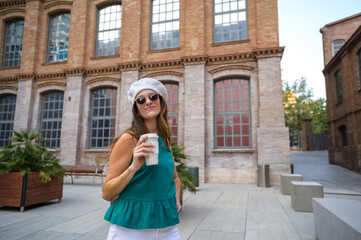 Fototapeta premium Stylish woman enjoying a coffee break in a european city