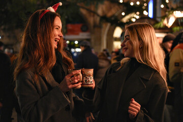 Friends enjoying festive holiday fair in Marienplatz