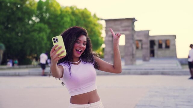 Tourist taking selfies in front of temple of debod in madrid