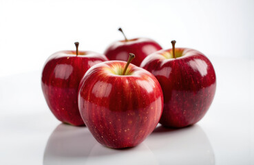Fresh red apples arranged on a white surface with a clean background