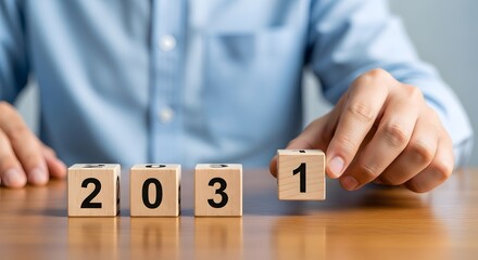 Planning for future years concept with wooden blocks showing year twenty thirty one and hand