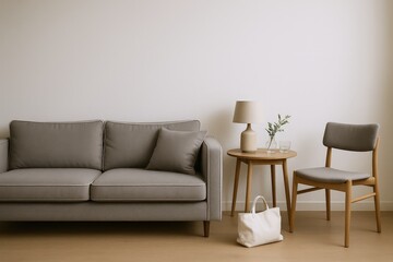 Modern Living Room Scene Featuring a Comfortable Grey Sofa, Accent Chair, and Minimalist Side Table with Lamp and Decor