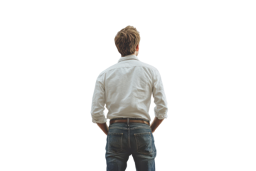 Man in jeans gazing upwards with a thoughtful expression while standing against an isolated background during daylight