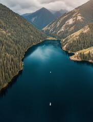 Aerial view of beautiful Kolsai Lakes, with tourists boats, located in the Tien Shan mountains, Kazakhstan