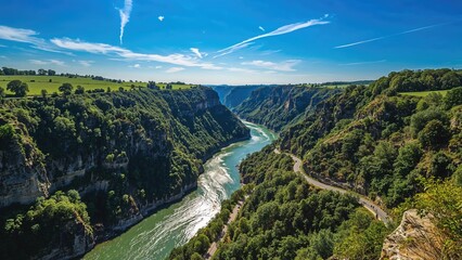 Bird's-eye view of a deep, tight river canyon crossed by a roadway, taken by drone.