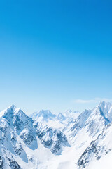 Fototapeta premium Snowy mountain peaks with blue sky background, crisp details, airy depth, wide and open copy space for marketing placement