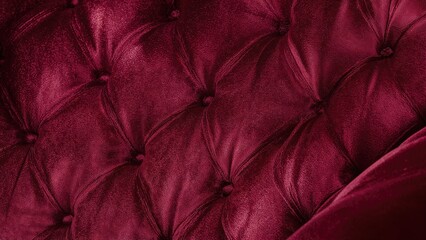 Naklejka premium Detailed close-up of velour material with buttoned quilting on furniture upholstery.