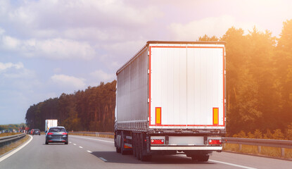 White cargo truck driving on rural highway