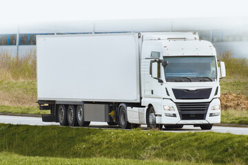 Freight truck moving on highway in sunlight