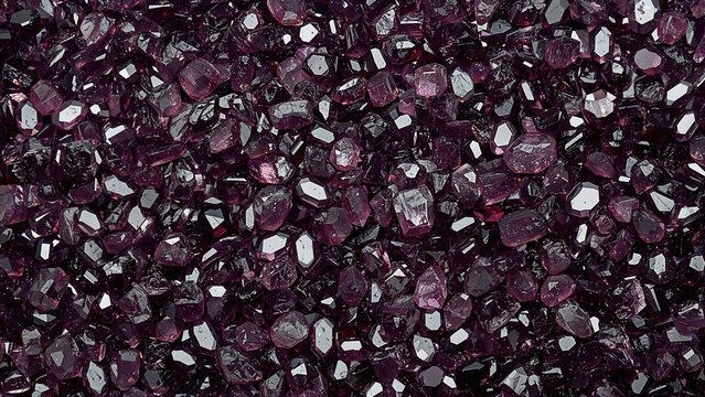 Crystals of violet garnet. Rich red jewels. Minerals found in nature. Textured appearance of both precious and semi-precious jewels. Shiny colored finishes on gemstones.
