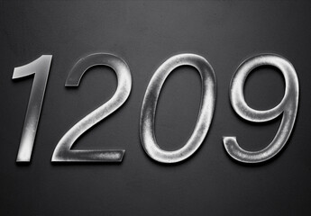 Chrome metal 3D number design of 1209 on grey background.