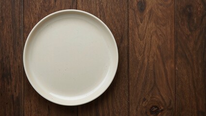 Isolated empty dinner plate over a wooden table for culinary purposes