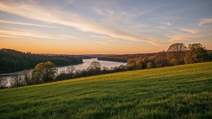 Obraz premium Sunset over lush green fields