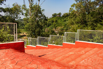 Sunlight Over Red Steps and Green Hill Trees in Chattogram.