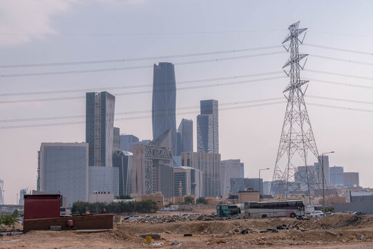 King Abdullah Financial District skyline in Riyadh, Saudi Arabia, displays modern skyscrapers amid desert sands and urban growth under daylight conditions.

