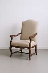 Fototapeta premium Elegant Upholstered Armchair with Carved Wooden Frame Showcasing Classic Design and Comfort