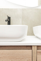 Contemporary bathroom with rectangular porcelain sink, chrome wall-mounted mixer, and corner shower enclosure