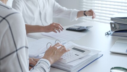 Close up of a calculator on financial documents, with an accountant hands working with, finance, and tax preparation. Audit and taxes in business