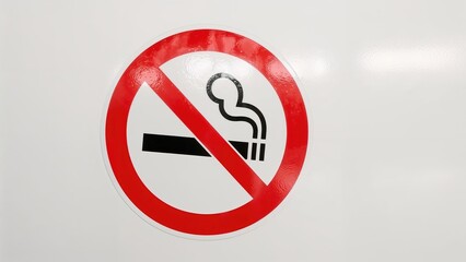 Fototapeta premium Public no smoking circular sticker featuring red and black design on white background
