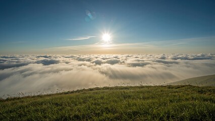 Fototapeta premium Meadow Surrounded by a Sea of Clouds