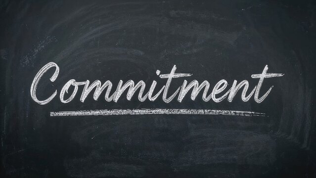 Commitment displayed on a blackboard, highlighting its role in work, education, and interpersonal connections.