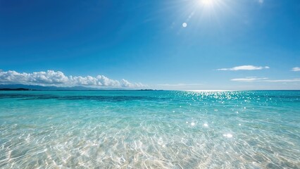 Obraz premium Tropical ocean in summer with glistening waves under a clear blue sky. Broad background template