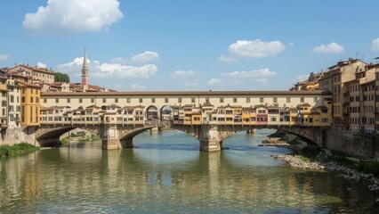 Fototapeta premium Historic stone segmental arch bridge crossing a flowing river surrounded by nature and architecture