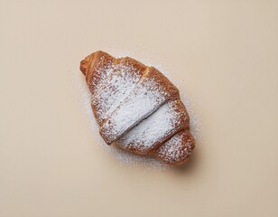 Naklejka premium Golden Croissant with Powdered Sugar on Beige Background
