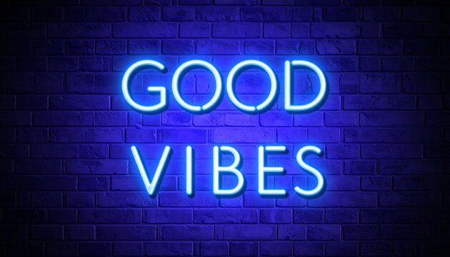Neon sign reading "good vibes" on a brick wall.