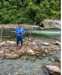 Solo tourist photographer enjoying at riverfront in Sikkim