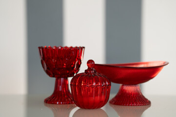 Red glass kitchen containers used for storing food or ingredients, adding a vibrant touch to kitchen decor