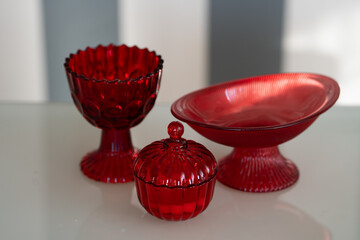 Red glass kitchen containers used for storing food or ingredients, adding a vibrant touch to kitchen decor
