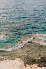 Crystal Clear Turquoise Waves Crashing on Rocky Shoreline