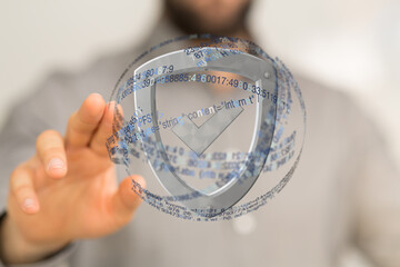 Hand interacting with a digital shield, showcasing data security and protection.