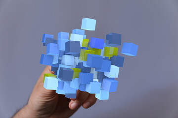 Hand holding blue and yellow cubes,digital data, network, connection, technology concept.