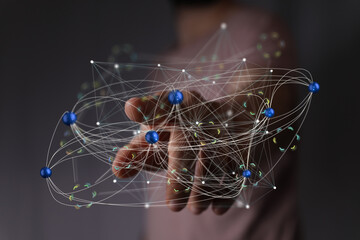 Abstract image of a hand interacting with a complex network of interconnected nodes, representing global communication and digital connections.