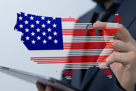 Businessman interacts with a digital US flag map on a tablet. Patriotic technology concept.