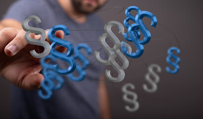 Abstract image of a hand interacting with floating paragraph symbols, representing legal concepts or digital law.