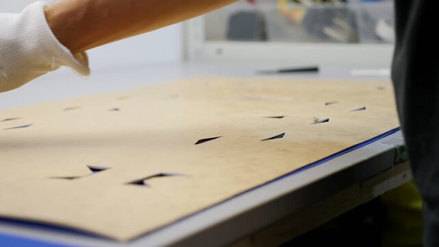 Close-up of a special machine for rolling sintepon in the atelier for the production of bags.